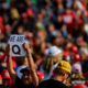 A woman holds up a QAnon sign to the media as attendees wait for President Donald Trump to speak at a campaign rally at Atlantic Aviation on September 22, 2020 in Moon Township, Pennsylvania.
